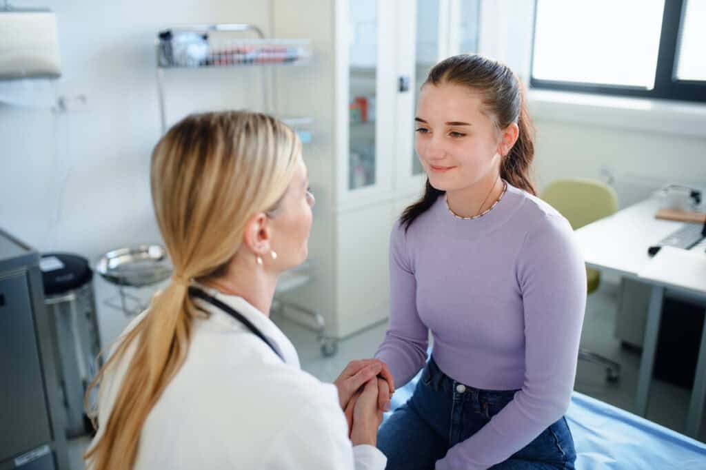 Pediatrician treating a teen