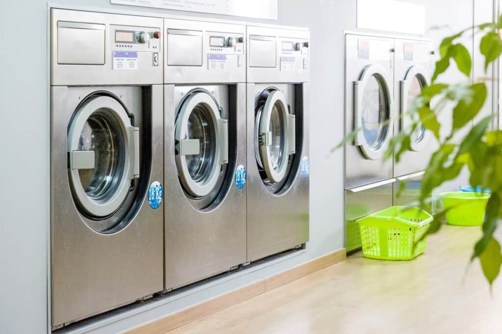 ITEC Laundry Corp: Voted Best Customer Service for Commercial Laundry Equipment and Service Provider in Louisiana 2026 4 Public laundry with modern, silver washing machines in a row